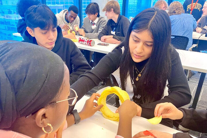 High school students build a structure with Pringles potato chips.